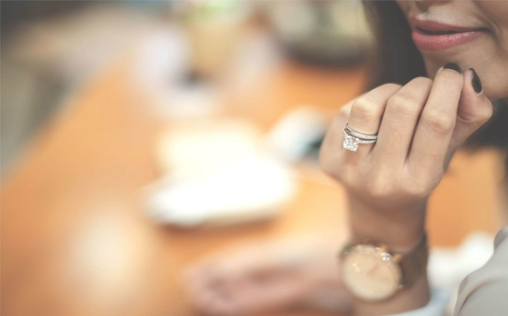 Lady posing with a diamond engagement ring