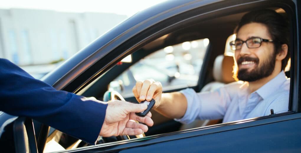 Car dealership handing over the keys to a car