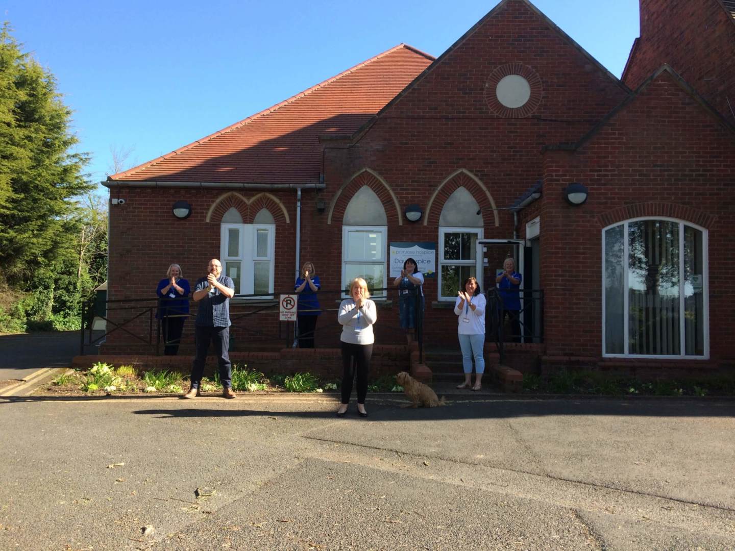 The carers of Primrose Hospice clapping outside their premises maintaining social distance