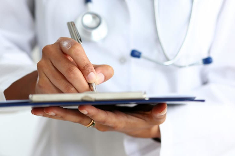 Doctor making a diagnosis on a clipboard