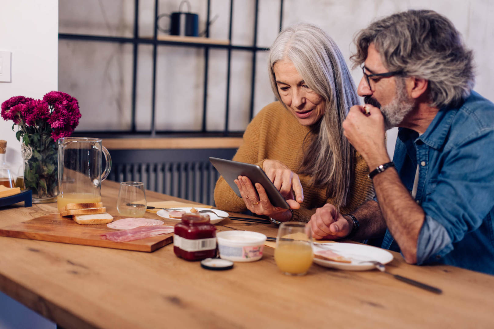 An older couple at home researching personal insurance cover. Get in touch with Jukes Insurance Brokers for help today.