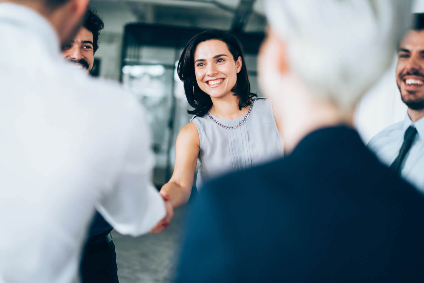 Female business person shaking hands with business associate